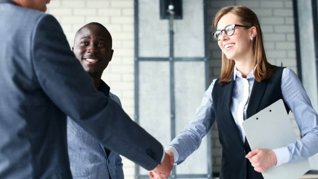 happy sales persons making a deal