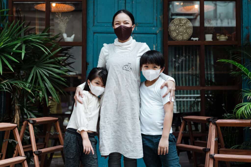 Mother and her children wearing colorful face masks