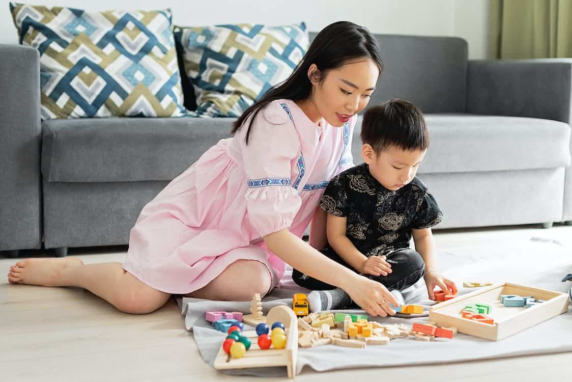 A mom and a child playing with toys