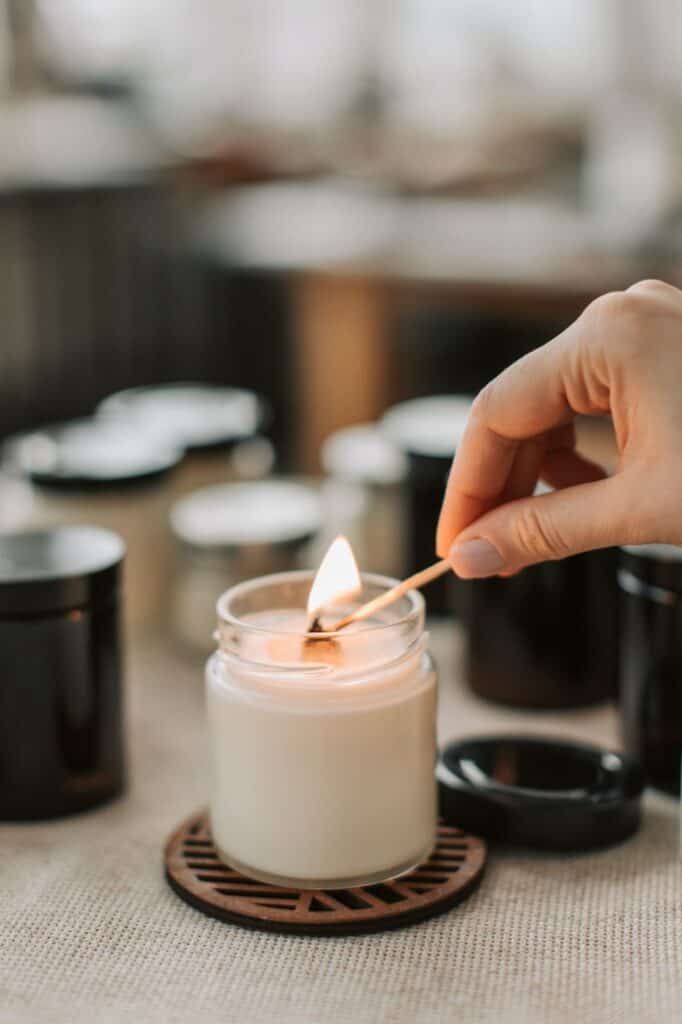 A person lighting a candle